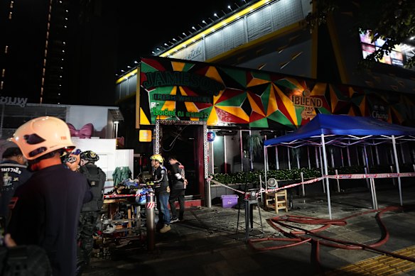 Rescuers work at the site of the pub fire in Bangkok.