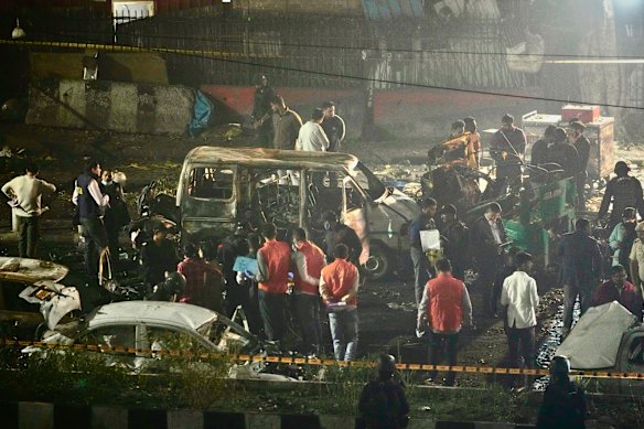 Security officers inspect the scene of a car explosion near the historic Red Fort in New Delhi, India.