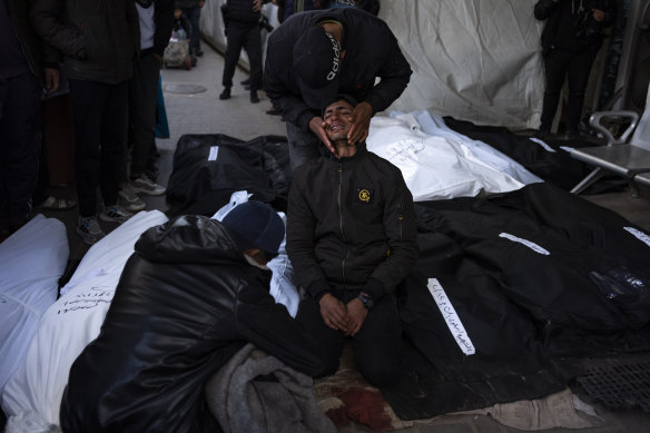 Palestinians mourn their relatives who were killed in the Israeli bombing of the Gaza Strip at a hospital morgue in Rafah.