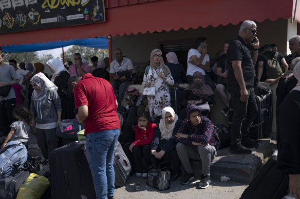 Palestinians wait to cross into Egypt at the Rafah border crossing in the Gaza Strip.