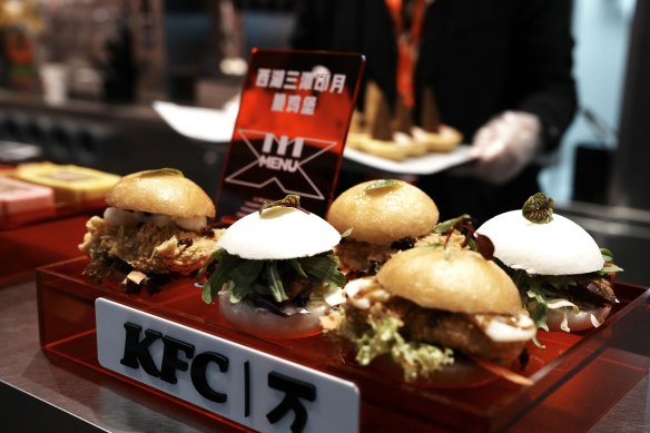 An employee prepares hamburgers at KFC China’s 10,000th store in Hangzhou, on the opening day in December 2023.