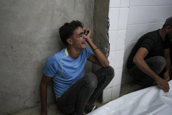 A young Palestinian mourns his relatives killed in the Israeli bombardment of the Gaza Strip at a hospital in Deir el-Balah, on Sunday.