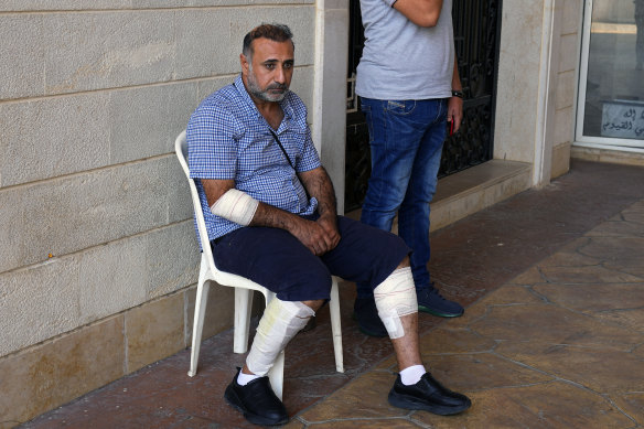 Iraqi Reuters photographer Thaer Al-Sudani, who was injured by Israeli shelling, attends the funeral procession of his colleague videographer Issam Abdallah, killed in the same shelling, in his hometown of Khiam, southern Lebanon. 