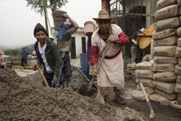 Workers build a house for the family of a neighbour who migrated to the US in the Mam Indigenous community of San Martin Sacatepequez, Guatemala.