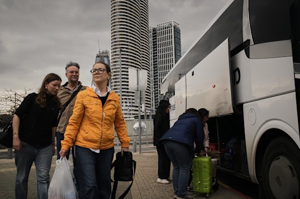 Tourists board buses bound for the Taba border crossing with Egypt to leave Israel, as Israeli airspace remained closed. 