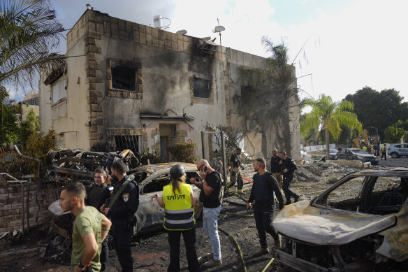 Israeli security forces examine the site hit by a rocket fired from Lebanon, in Kiryat Bialik, northern Israel.