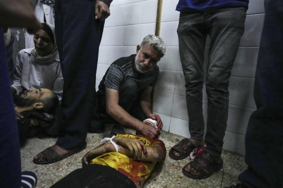 Palestinians mourn their relatives killed in the Israeli bombardment of the Gaza Strip, at the Al Aqsa hospital in Deir al Balah, Gaza on Friday.