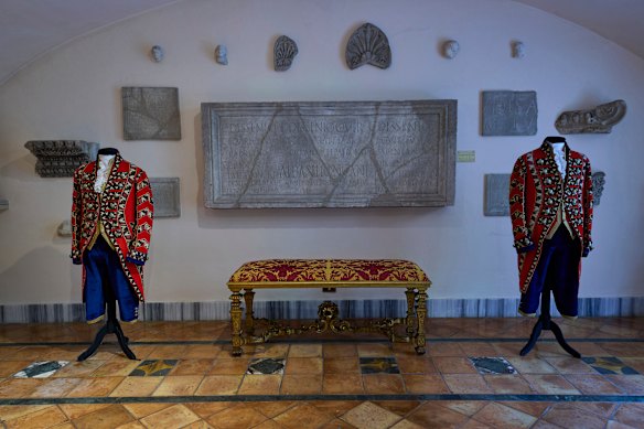 Ceremonial uniforms worn by palace staff are displayed in the prince’s apartments.