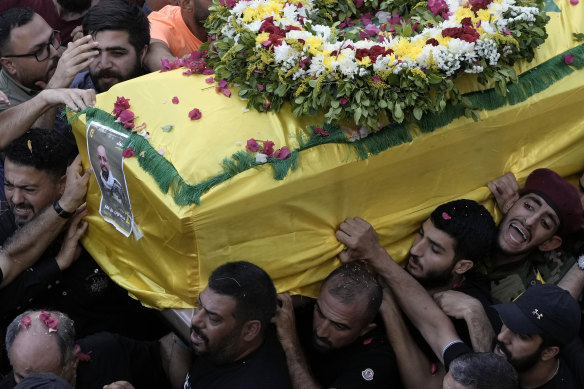 Hezbollah fighters carry the coffin of a person killed by an exploding pager in Beirut, Lebanon.