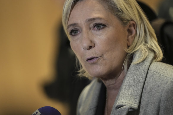 French far-right leader Marine Le Pen speaks to the media as she arrives at the courthouse in Paris on Monday. The trial is expected to last two months.