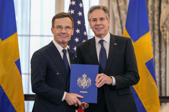 US Secretary of State Antony Blinken, right, and Swedish Prime Minister Ulf Kristersson hold Sweden’s NATO Instruments of Accession at the US State Department in Washington.
