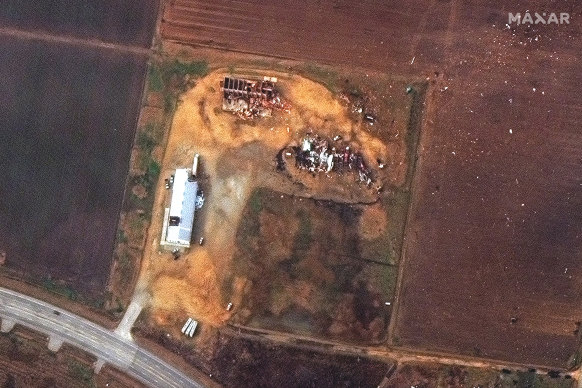 A satellite photo provided by Maxar shows farm buildings in Monette, Arkansas, after they were hit by a tornado. 