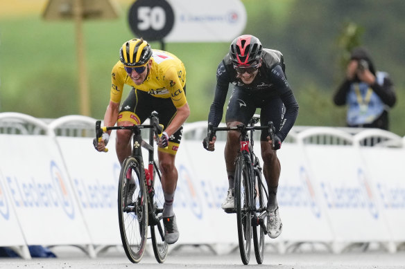 Tadej Pogacar, left, retained the overall leader’s yellow jersey.