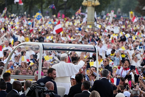 The vehicle paused frequently as people waved white and yellow Vatican flags and Leo blessed people with disabilities, children and babies passed forward by volunteers.