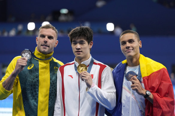 Gold medallist Pan Zhanle poses with silver medallist Kyle Chalmers and bronze medallist David Popovici.