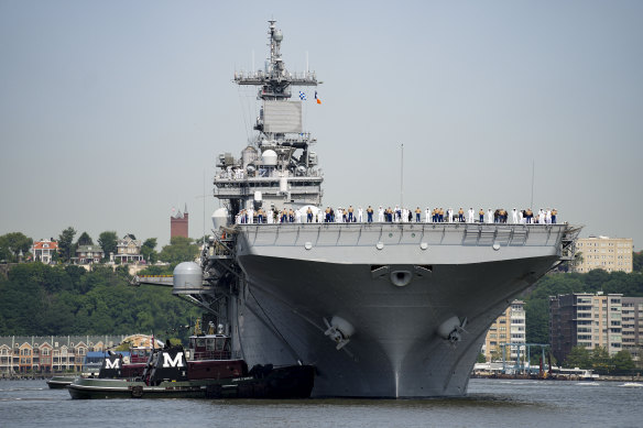 Sailors and military service personnel arrive on the USS Wasp amphibious assault ship on the Hudson River during fleet week in New York.