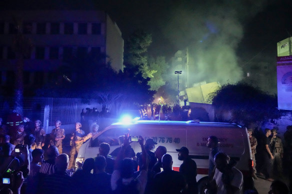 First responders: Ambulances arrive at the site of an Israeli airstrike in Beirut’s southern suburbs on Friday.