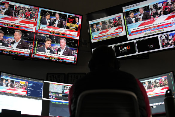 Inside the Right Side Broadcasting Network control room while former president Donald Trump speaks at a campaign rally.