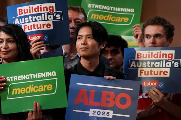 Labor supporters also hold Medicare placards.