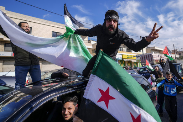 Syrians celebrate the fall of president Bashar al-Assad’s regime in the Lebanese town of Bar Elias, near the Syrian border.