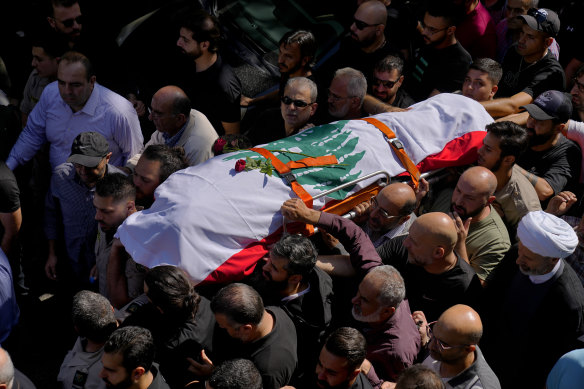 Mourners carry the body of Reuters videographer Issam Abdallah on Saturday.