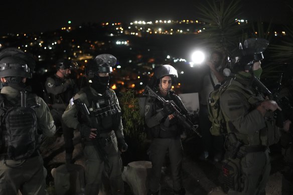 Police are present before the release of Palestinian prisoner Israa Jaabis as part of a deal between Israel and Hamas on November 26 in the Jabel Mukaber neighbourhood of East Jerusalem. 