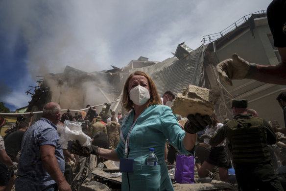 Emergency workers at the site of a Russian missile attack on the Ohmatt-Dit children's hospital.