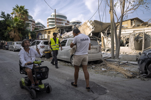 Israelis inspect the rubble of a building after it was hit by a rocket fired from Gaza.