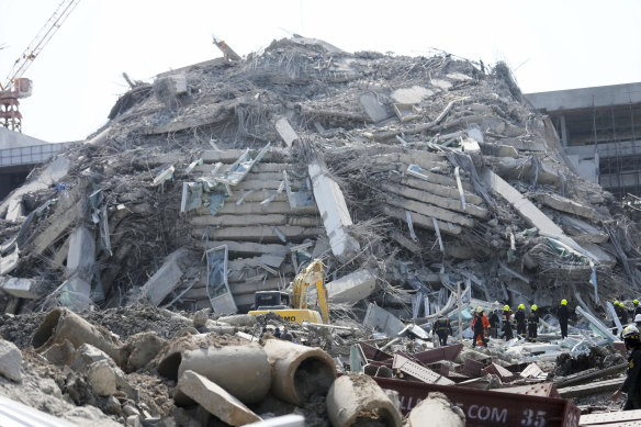 Thai rescue workers arrive on the scene of the collapsed building in Bangkok.