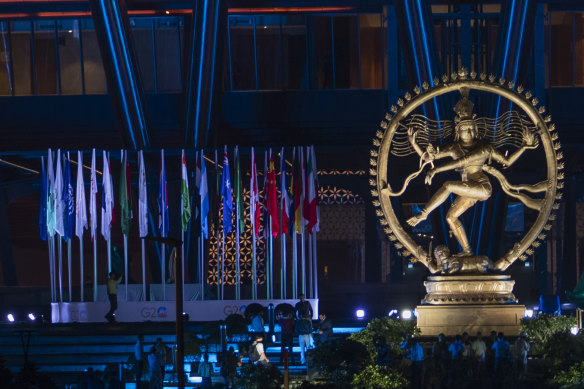 An illuminated statue of Nataraja, the Hindu god of dance, stands at the entrance of the main venue for the G20 summit in Delhi, India.