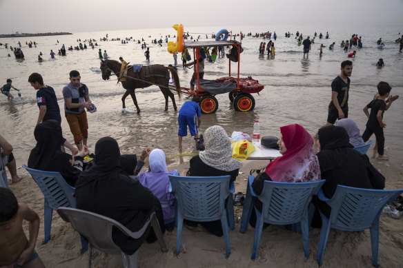 Palestinians enjoy the day on the beach by the Mediterranean Sea during a heat wave in Gaza City before the Hamas-Israel war in June last year.