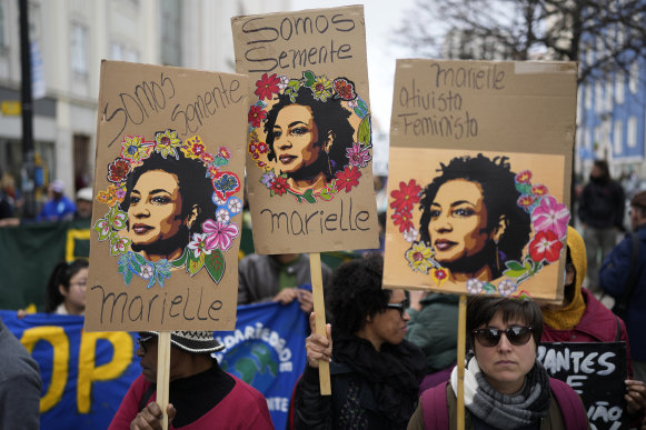 People carry posters with images of slain Brazilian councilwoman Marielle Franco during a demonstration against racism in Lisbon, Portugal, last month.