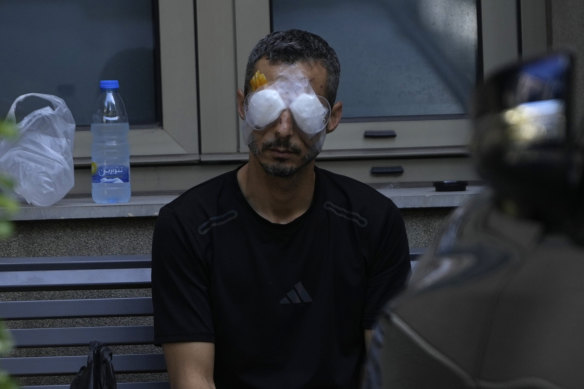 A man injured when a handheld device exploded waits in a specialist eye hospital in Beirut.