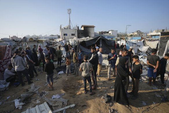 Palestinians at the site of an Israeli strike in the courtyard of a hospital where displaced people live in tents, in Deir al-Balah, Gaza Strip on Saturday.
