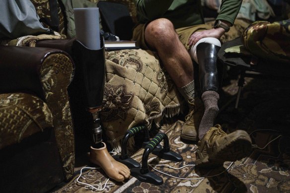 Maksym Vysotskyi sits on a sofa near the front line.