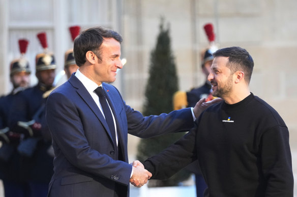French President Emmanuel Macron, left, welcomes Ukrainian President Volodymyr Zelensky at the Elysee palace in Paris on Sunday.
