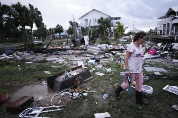 Jewell Baggett searches for anything salvageable from the wreckage of her mother’s home, in Horseshoe Beach, Florida, after the passage of Hurricane Idalia.