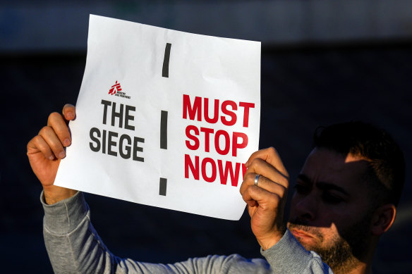 A member of international humanitarian group Doctors Without Borders holds a placard during a protest called for an end to the war in Gaza and for an immediate cease-fire, at Martyrs’ Square in downtown Beirut, Lebanon, on Monday.