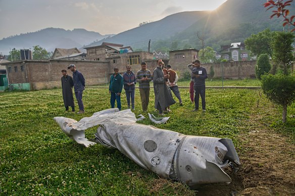 Unidentified aircraft debris lies on the ground near a mosque in Indian-controlled Kashmir.