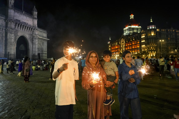 People light fireworks as they celebrate New Year’s Eve near the iconic Gate way of India, in Mumbai.