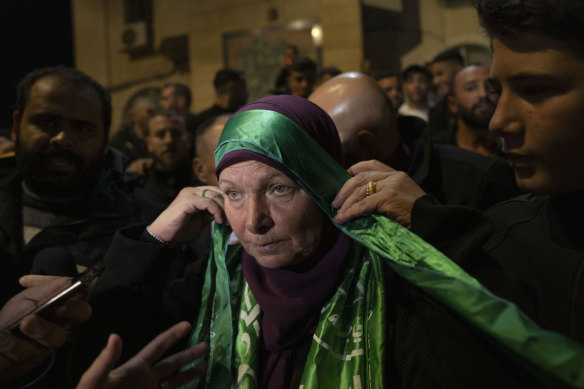 Hanna Barghouti, released by Israeli authorities, wears a Hamas headband on arrival in the West Bank town of Beitunia.