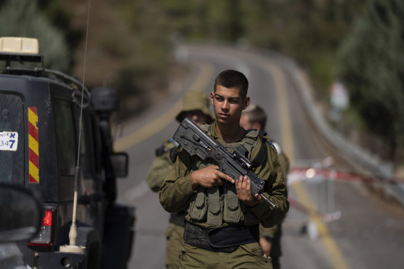 Israeli soldiers guard a check point near the border with Lebanon, in Israel on Saturday.