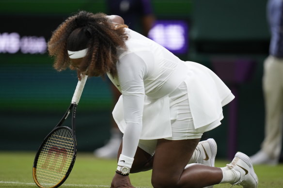 Serena Williams falls during her first-round match.