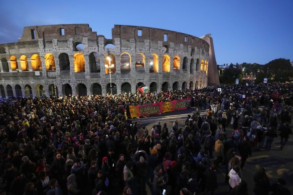 Demonstrators march on the occasion of International Day for the Elimination of Violence against Women in front of the ancient Colosseum, in Rome.