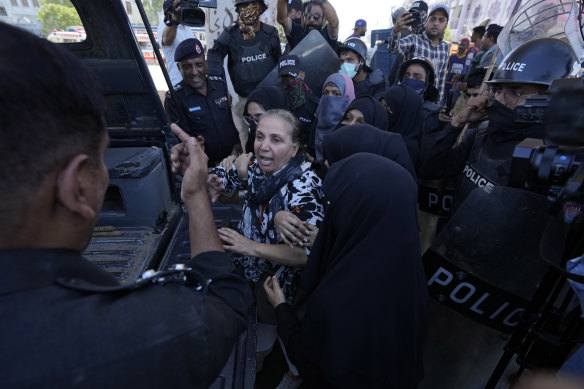 Police arrest an Imran Khan supporter in Karachi.