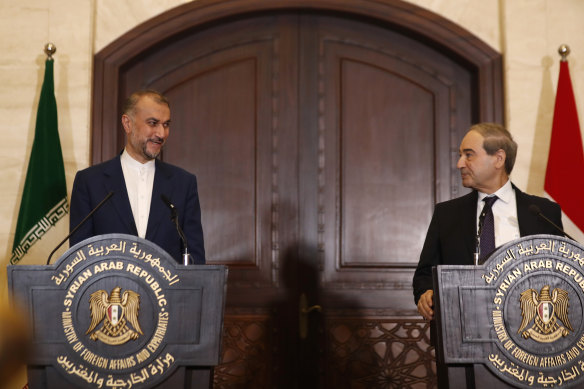 Syrian Foreign Minister Faisal Mekdad, right, speaks with Iranian Foreign Minister Hossein Amir-Abdollahian during a joint press conference in Damascus on Monday.