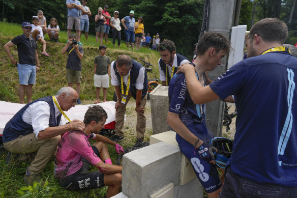 James Shaw and Romain Bardet get medical care after a crash on the fourteenth stage.