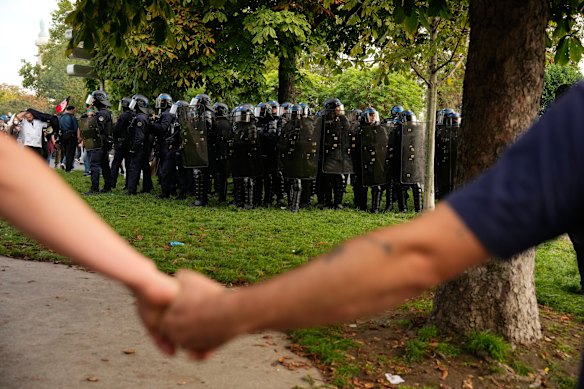 Protesters face police in Paris.