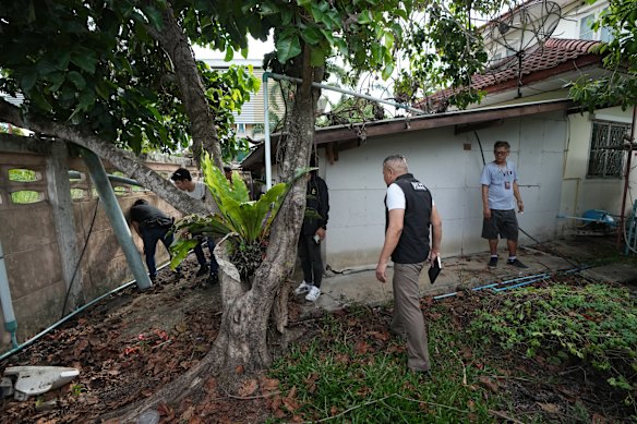 Police search the suspect’s home.