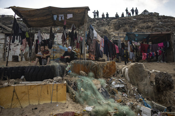 Palestinians dry their clothes after washing them with seawater at the beach in Deir al-Balah, Gaza Strip, in November.